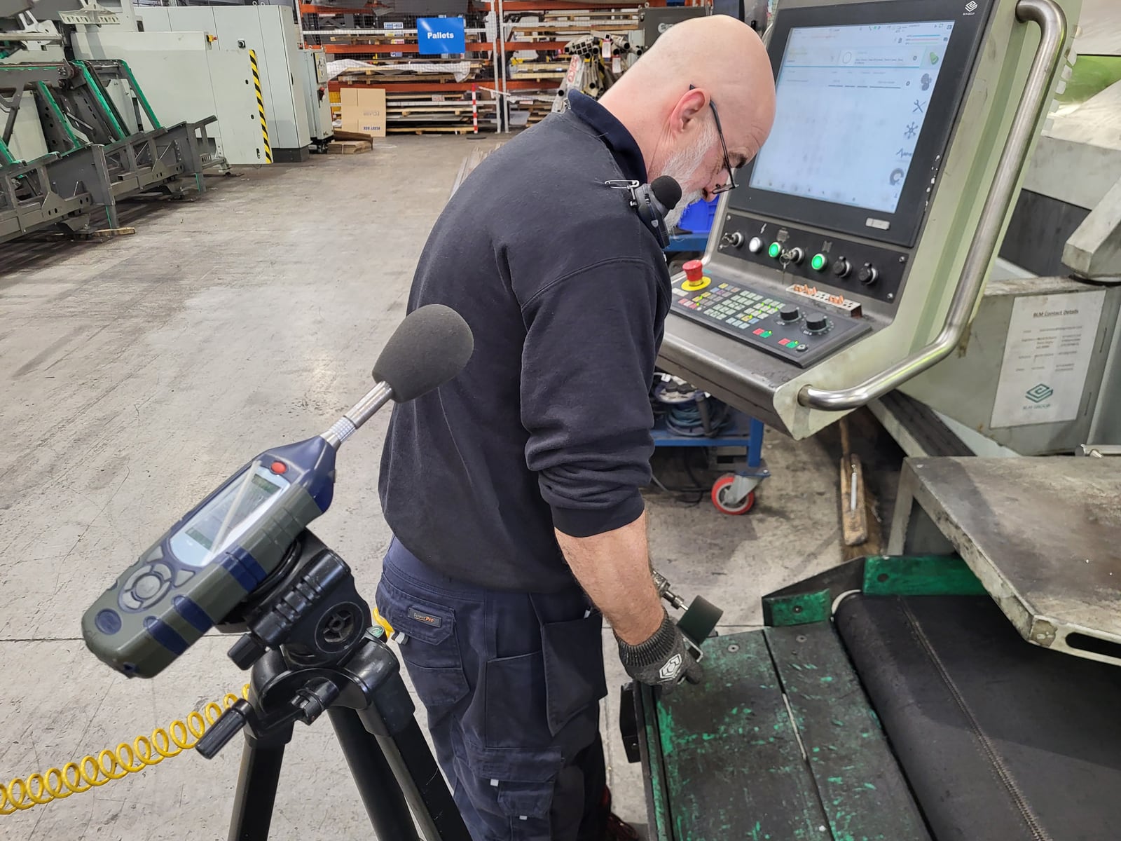 Workplace noise measurement beside industrial machinery